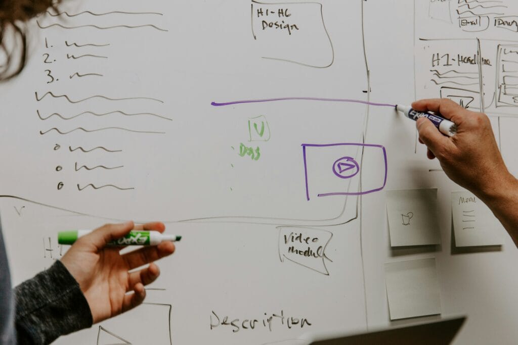 Team collaborating on a content marketing strategy with whiteboard and notes