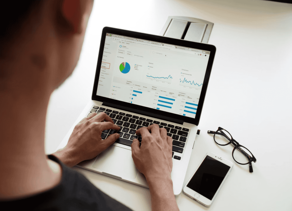 Professional reviewing marketing automation analytics and reports on a laptop